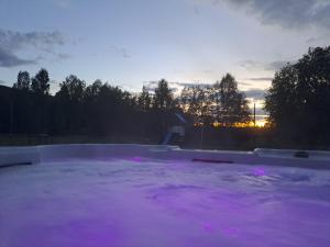 a pool of purple water with the sunset in the background at Lilov in Sysslebäck