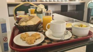 a tray of food with bread and coffee and toast at Hotel Costa Pacifico - Express in Antofagasta