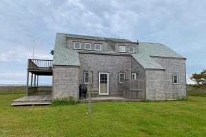 a large brick house with a porch and a deck at Valleys & Views in Nantucket
