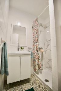 a bathroom with a shower and a sink and a tub at Sweet Home Apartaments in El Médano