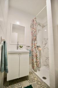 a bathroom with a shower and a sink and a tub at Sweet Home Apartaments in El Médano +26 photos