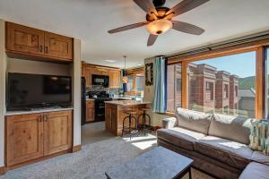 Una sala de estar con un sofá y un ventilador de techo. en Peak 9 Studio of Dreams, en Breckenridge