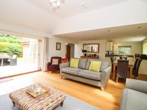 a living room with a couch and a table at Oak Tree Lodge in Rackheath