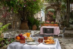 a table with food and fruit on it with a table with a table at Archontiko Stamou in Zagora