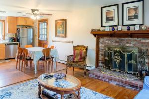 a living room with a table and a fireplace at Pet-Friendly West Yarmouth Home, Half Mi to Beach! in West Yarmouth