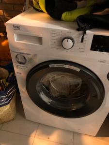 a white washing machine sitting on a counter at Be like at home New York in Alcalá de Henares