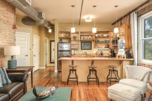 a living room with a kitchen with a bar at Nooga Loft in Chattanooga