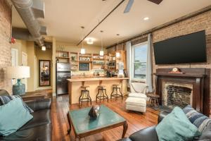 a living room with a fireplace and a tv at Nooga Loft in Chattanooga