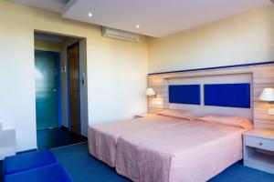 Postel nebo postele na pokoji v ubytování Mariandy Hotel