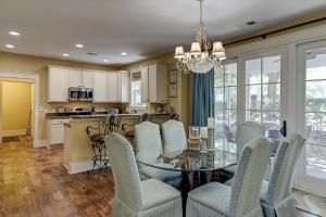 a kitchen and dining room with a glass table and chairs at North Beach Coastal Breeze in Myrtle Beach