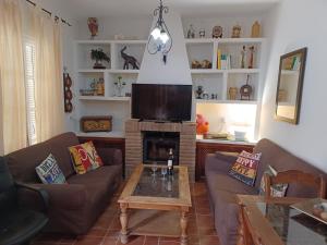 a living room with a couch and a fireplace at Casa Almoraima in Gaucín