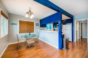 a kitchen and dining room with blue walls and a table and chairs at The Salty Dog in Newport Beach