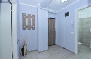 a white bathroom with a shower and a toilet at Residenza di Carbasinni in Bucharest