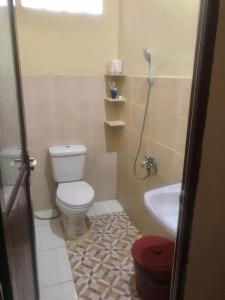 a bathroom with a toilet and a sink at New Bunga Sonsang Homestay Syariah in Tabing