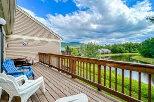 a deck with chairs and a view of a river at White Mountain Retreat in Lincoln