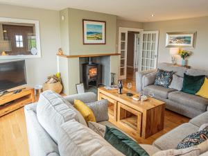 a living room with couches and a fireplace at Corsewall Castle Farm Lodges in Kirkcolm