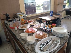 a kitchen counter with plates of food on it at Cantinho do Brejo Pousada in Guarabira