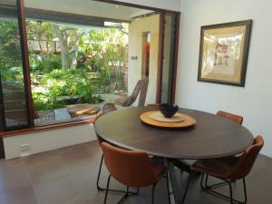 a dining room table with a bowl on top of it at The Sanctuary - garden oasis in South Fremantle in South Fremantle