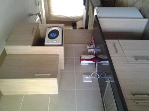 a small bathroom with wooden cabinets and a scale at Airport Lodge Guest House in Kempton Park