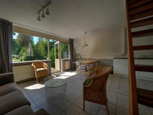 cocina y sala de estar con mesa y sillas en Cosy holiday home in Eerbeek with balcony terrace en Eerbeek