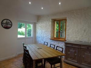 a dining room with a wooden table and chairs at Semi-detached house, St Sauveur-le-Vicomte in Saint-Sauveur-le-Vicomte