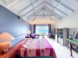 a bedroom with a large bed and a large window at Blue Room in a shared Villa Diamant with communal pool and sea view in Grand Case
