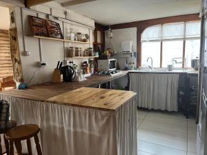 a kitchen with a wooden counter top in a room at Casa Balmaceda Backpackers in Coihaique