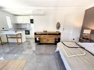 a large room with a kitchen and a bed in it at Studio Aloe in shared Villa Diamant, infinity pool, sea view in Grand Case