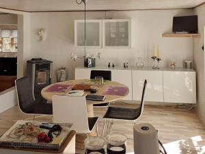 a kitchen with a table and chairs in a room at Holiday home Taastrup in Tåstrup