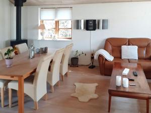 a living room with a table and a couch at Holiday home Taastrup in Tåstrup