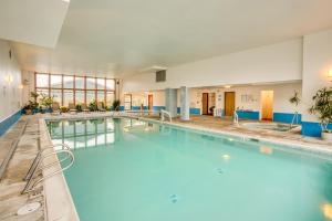 a large swimming pool with blue water in a building at Adobe Resort in Yachats