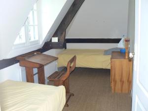 a room with two beds and a desk and a chair at Estate in Normandy with Pool & Tennis Court in Le Mesnil-sur-Blangy +41 photos