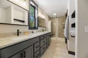 a bathroom with two sinks and a shower at 24 KARAT Lodge at Terry Peak in Lead +31 photos