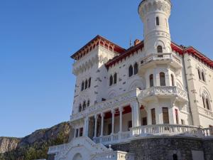 a white building with a tower on top of it at Appartement T3 dans Château avec Piscine et Sauna à Jausiers - 6 pers, 55m² - FR-1-165B-32 in Jausiers