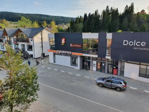 a car parked in a parking lot in front of a building at Едем in Skhidnitsa +42 photos