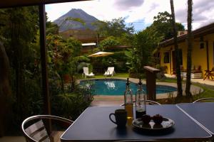 a table with a plate of food and two bottles of wine at Hotel Arte Natura in Fortuna