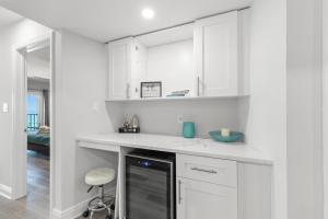 a white kitchen with white cabinets and a dishwasher at Las Brisas 306 in St Pete Beach +33 photos