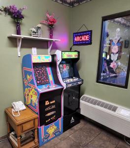 a room with two arcade games and a phone at Super 8 by Wyndham Cut Bank in Cut Bank