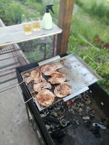 a grill with a bunch of food cooking on it at Сясьстрой Уютный дом in Podryabin'ye