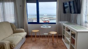 salon z kanapą, stołem i oknem w obiekcie APARTAMENTO ROQUE DEL ESTE w mieście Orzola