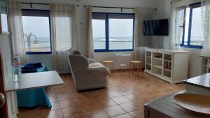 a living room with a view of the ocean at APARTAMENTO ROQUE DEL ESTE in Orzola