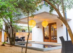 a home with yellow lanterns in the yard at O2 Villas Yala in Yala