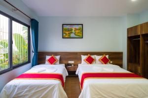 Postel nebo postele na pokoji v ubytování Golden Field Villa Hoi An