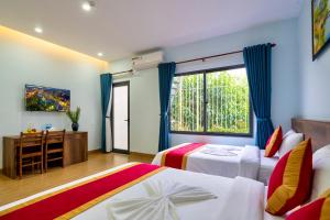 Postel nebo postele na pokoji v ubytování Golden Field Villa Hoi An