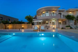 a villa with a swimming pool in front of a house at Villa Vicky in Zakynthos Town