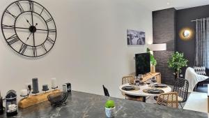 a dining room with a large clock on the wall at Black&White Home-by So'SerenityHome-Balcon-Parking in Cluses