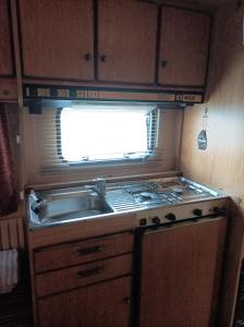 an rv kitchen with a sink and a stove at Camping Malkiq oazis in Ezerets