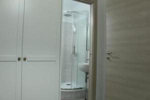 a bathroom with a glass shower and a sink at B&B il Melograno in Paulilatino