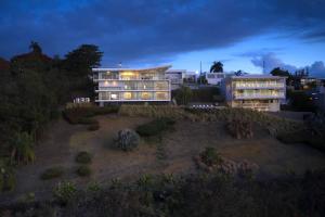 a large building on a hill at night at Happy Days Villa C in Fajardo