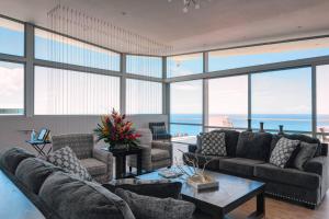 a living room with couches and a view of the ocean at Happy Days Villa C in Fajardo